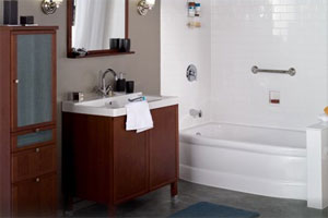 Bathroom featuring a vanity with brown cabinets and a large mirror alongside a bathtub.