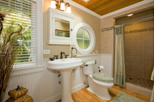 A beautiful bathroom with traditional appliances and a walk-in shower.