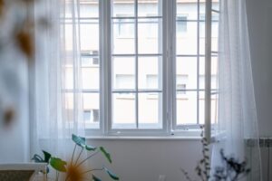 Close up of beautiful white window with flowy curtains