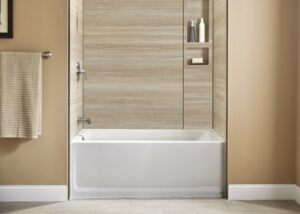 Front view of white deep soaker tub with beige walls and wood grain wall surround